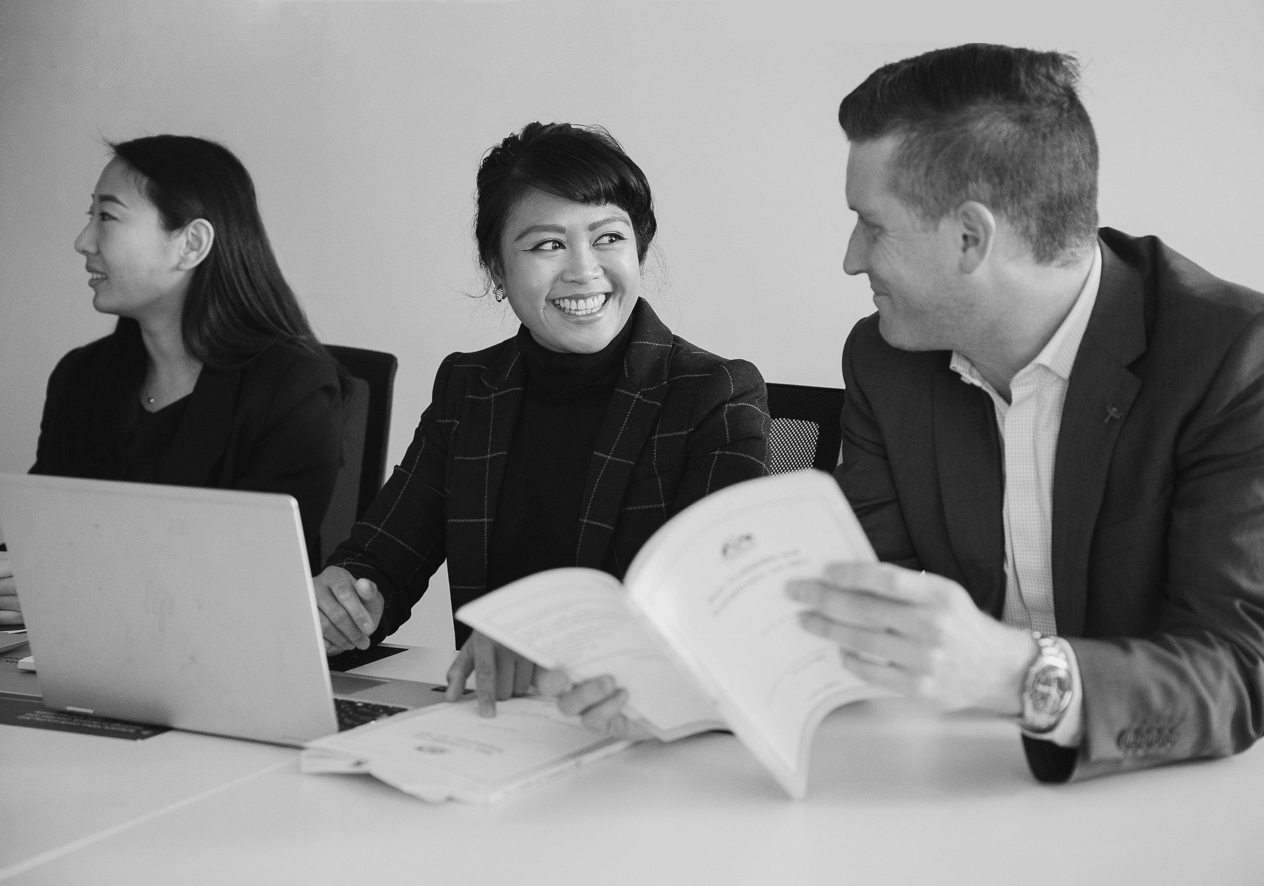 Three office workers communicating about the Data Availability and Transparency Act 2022.